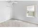 Well-lit bedroom with a ceiling fan, plush carpet, window, and closet at 484 Sherwood Oaks Rd, Orange City, FL 32763