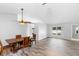 Dining room featuring wood floors, updated lighting, and ample natural light at 484 Sherwood Oaks Rd, Orange City, FL 32763