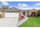 Charming single-Gathering home features a brick facade and well-manicured lawn at 484 Sherwood Oaks Rd, Orange City, FL 32763