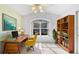 Inviting home office featuring built in book-shelving and a work desk with view of the outdoors at 484 Sherwood Oaks Rd, Orange City, FL 32763