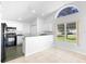 Kitchen showcases white cabinets, black appliances, and a sunlit breakfast nook at 484 Sherwood Oaks Rd, Orange City, FL 32763