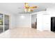 Living room has tile flooring and a ceiling fan, with views to other rooms at 484 Sherwood Oaks Rd, Orange City, FL 32763