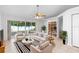 Bright living room with modern furnishings, tile floors, and sliding glass doors to lanai at 484 Sherwood Oaks Rd, Orange City, FL 32763