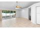 Living room features neutral tile flooring, a ceiling fan, and sliding glass doors leading outside at 484 Sherwood Oaks Rd, Orange City, FL 32763