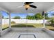 The covered screened patio includes a ceiling fan and offers a relaxing view of the lush fenced yard at 484 Sherwood Oaks Rd, Orange City, FL 32763