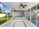 Enjoy the view of this tiled screened patio, complete with ceiling fan and views of the landscaped backyard and adjacent patio at 484 Sherwood Oaks Rd, Orange City, FL 32763