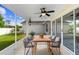 Enjoy the outdoors on this screened patio with ceiling fan, tile floors, and a view of the spacious, fenced backyard at 484 Sherwood Oaks Rd, Orange City, FL 32763
