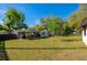 Large backyard featuring a patio, lush lawn, and mature trees, great for entertaining at 501 Powers Ave, Port Orange, FL 32127