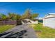 Fenced backyard with garage and outbuilding and driveway at 501 Powers Ave, Port Orange, FL 32127
