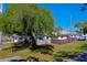 Charming home exterior with large shade tree, shed, and fenced yard at 501 Powers Ave, Port Orange, FL 32127