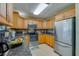 Kitchen featuring stainless steel appliances, wood cabinetry, and tile flooring at 501 Powers Ave, Port Orange, FL 32127