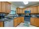 Kitchen featuring stainless steel appliances, wood cabinetry, and a modern sink at 501 Powers Ave, Port Orange, FL 32127