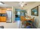 Kitchen and dining area with stainless steel refrigerator and view into living room at 501 Powers Ave, Port Orange, FL 32127