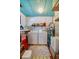Functional laundry room with a washer, dryer, storage shelves, and blue ceiling at 501 Powers Ave, Port Orange, FL 32127
