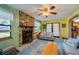 Cozy living room with a stone fireplace, carpeted floors, and natural light at 501 Powers Ave, Port Orange, FL 32127