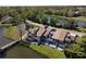 Aerial view of grey townhouses near a lake with a pedestrian bridge, landscaped for curb appeal at 509 Lake Bridge Dr, Ormond Beach, FL 32174