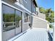 Exterior balcony with sliding glass door overlooking the water and greenspace at 509 Lake Bridge Dr, Ormond Beach, FL 32174