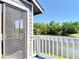 Balcony view overlooking water with trees in the background, secured by a white railing at 509 Lake Bridge Dr, Ormond Beach, FL 32174