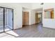 Open and airy room with wood floors and a sliding glass door leading to the outdoor balcony at 509 Lake Bridge Dr, Ormond Beach, FL 32174
