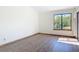 Well-lit bedroom with wood floors and a large window showcasing the lush landscape at 509 Lake Bridge Dr, Ormond Beach, FL 32174