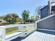 Exterior grey siding with white railing overlooking a waterfront area with a bench at 509 Lake Bridge Dr, Ormond Beach, FL 32174