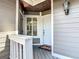 Inviting front entryway with a solid white door, porch, and a decorative light fixture at 509 Lake Bridge Dr, Ormond Beach, FL 32174