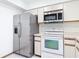 Modern kitchen with stainless steel refrigerator, white oven, and ample counter space for food preparation at 509 Lake Bridge Dr, Ormond Beach, FL 32174