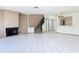 Spacious living room with fireplace, staircase, tile flooring, and open access to kitchen at 509 Lake Bridge Dr, Ormond Beach, FL 32174
