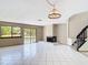 Spacious living room with tile flooring, fireplace, staircase, and sliding doors to the backyard at 509 Lake Bridge Dr, Ormond Beach, FL 32174