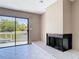 Cozy living area with fireplace and sliding glass doors leading to a deck with waterfront views at 509 Lake Bridge Dr, Ormond Beach, FL 32174