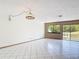 Bright living room with tile flooring, large windows and sliding glass door with views of the backyard at 509 Lake Bridge Dr, Ormond Beach, FL 32174