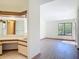 Bright main bedroom with wood-look floors and a large window overlooking the yard at 509 Lake Bridge Dr, Ormond Beach, FL 32174