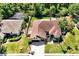 Aerial view of a well-maintained single-Gathering home featuring lush landscaping and a spacious backyard at 5808 Oak Lake Trl, Oviedo, FL 32765