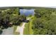 Panoramic aerial shot of community amenities featuring tennis courts, a park, and a tranquil lake at 5808 Oak Lake Trl, Oviedo, FL 32765