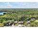 Scenic aerial view of a residential neighborhood surrounded by verdant trees, with a lake visible in the distance at 5808 Oak Lake Trl, Oviedo, FL 32765