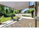 Charming back patio with shade cover, lounge chairs, and a peaceful yard at 5808 Oak Lake Trl, Oviedo, FL 32765