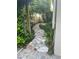 Stone path winds through lush backyard landscaping, leading to a relaxing hammock area at 5808 Oak Lake Trl, Oviedo, FL 32765
