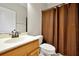 This bathroom has a shower and toilet next to a light wood vanity at 5808 Oak Lake Trl, Oviedo, FL 32765