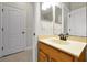 This bathroom features a light wood vanity and a bright mirror at 5808 Oak Lake Trl, Oviedo, FL 32765
