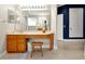 Well-lit bathroom vanity with wood cabinets and lots of light, featuring tile floors at 5808 Oak Lake Trl, Oviedo, FL 32765