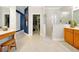 Open bathroom space with walk-in closet, large vanity, and glass shower stall at 5808 Oak Lake Trl, Oviedo, FL 32765