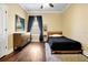 This bedroom features a wood-framed bed and dresser with a dark rug on hardwood floors at 5808 Oak Lake Trl, Oviedo, FL 32765