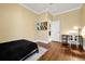 This bedroom offers hardwood floors, a desk and television, and a modern feel at 5808 Oak Lake Trl, Oviedo, FL 32765