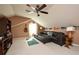 This bonus room features a large sofa, carpet, television, and natural lighting at 5808 Oak Lake Trl, Oviedo, FL 32765
