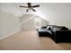 This bonus room offers a window, carpet, and an oversized black leather sofa at 5808 Oak Lake Trl, Oviedo, FL 32765