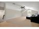 This bonus room offers a window, carpet, and an oversized black leather sofa at 5808 Oak Lake Trl, Oviedo, FL 32765