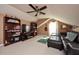 Upstairs bonus room is cozy with a ceiling fan and large sofa at 5808 Oak Lake Trl, Oviedo, FL 32765