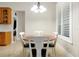 Bright dining room featuring wood table with chairs, white shutters, and tile flooring at 5808 Oak Lake Trl, Oviedo, FL 32765