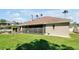 Exterior view of home featuring a screened patio and adjacent shaded patio at 5808 Oak Lake Trl, Oviedo, FL 32765