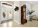 Bright foyer with double doors, tile flooring, and a vintage grandfather clock at 5808 Oak Lake Trl, Oviedo, FL 32765